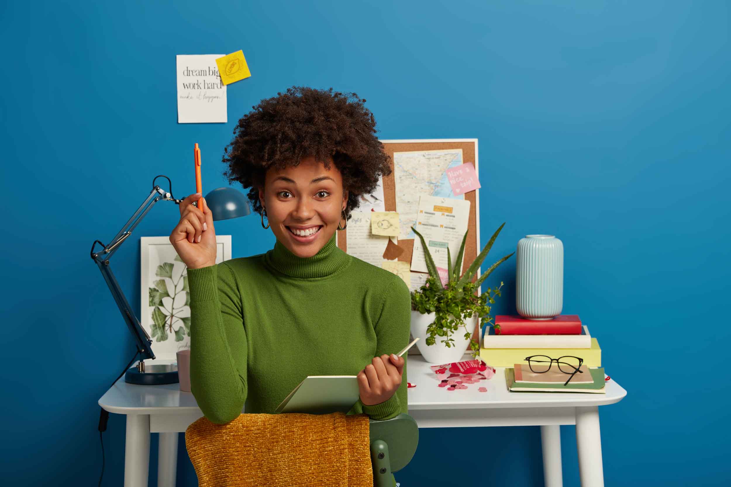 pretty-curly-young-woman-writes-notes-summary-holds-notepad-pen-prepares-test-session-exam-enjoys-studying-working